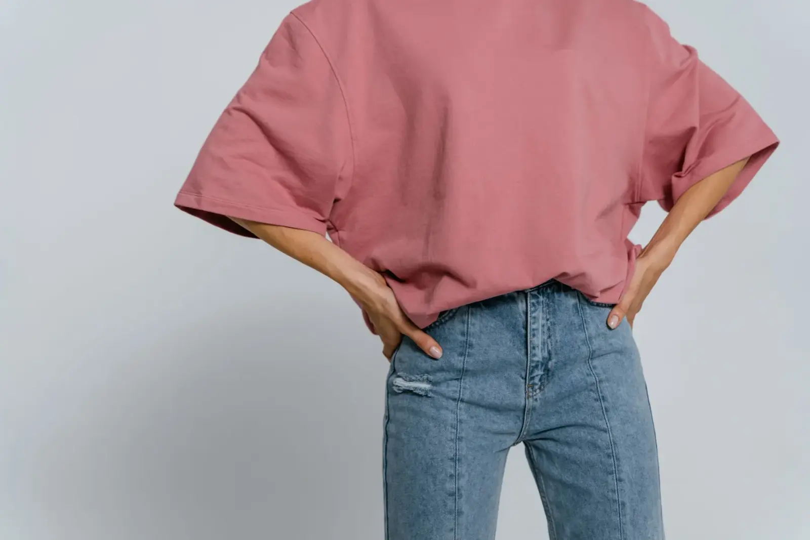 Áo thun hồng phối quần jean, chụp trong studio nền tối giản